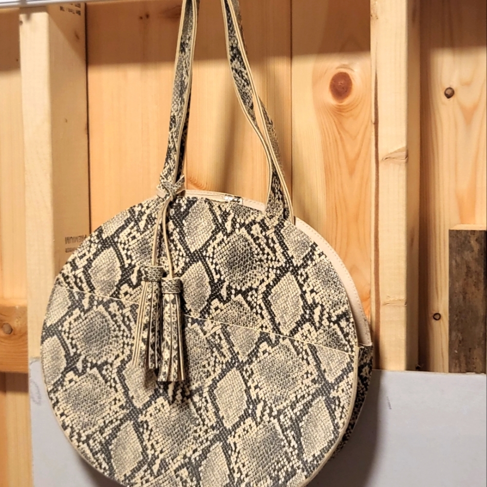 MUST GO, HUGE PRICEUnique, round handbag with tassels, animal print, super cool